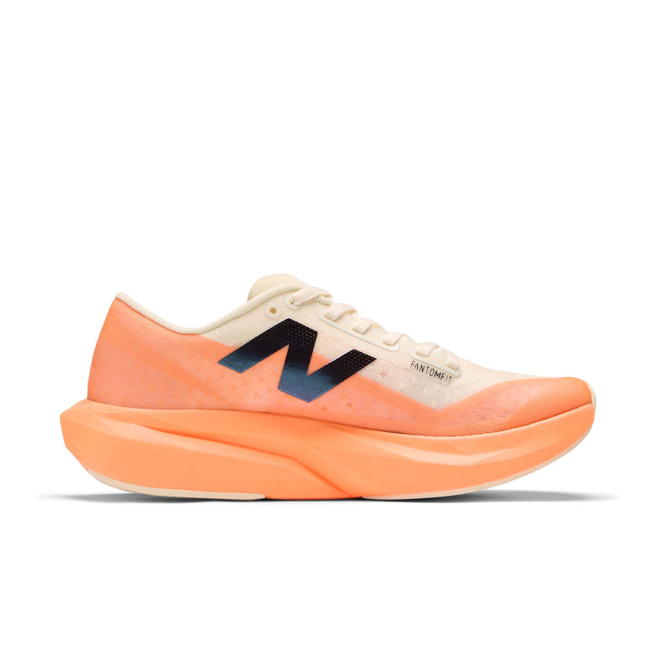 Medial view of the left shoe from a pair of New Balance Women's FuelCell Rebel V4 Running Shoes in the Hot Mango colourway. (8569898369186)